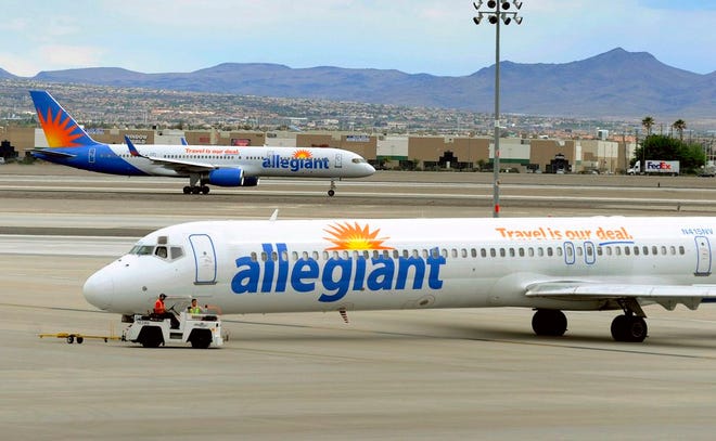 In this Thursday, May 9, 2013, file photo, two Allegiant Air jets taxi at McCarran International Airport in Las Vegas. (AP Photo/David Becker,File)