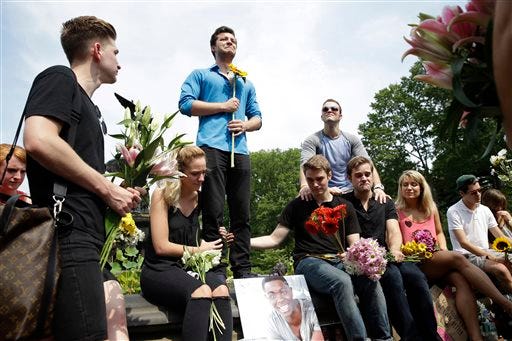Brandyn Day, center, talks about his best friend during a memorial gathering for Kyle Jean-Baptiste, Monday, Aug. 31, 2015, at Bethesda fountain in New York's Central Park. Baptiste, the first African-American and youngest person to ever play the role of Jean Valjean in "Les Miserables" on Broadway, died after falling from a fire escape over the weekend, according to a show spokesman. He was 21. (AP Photo/Mary Altaffer)