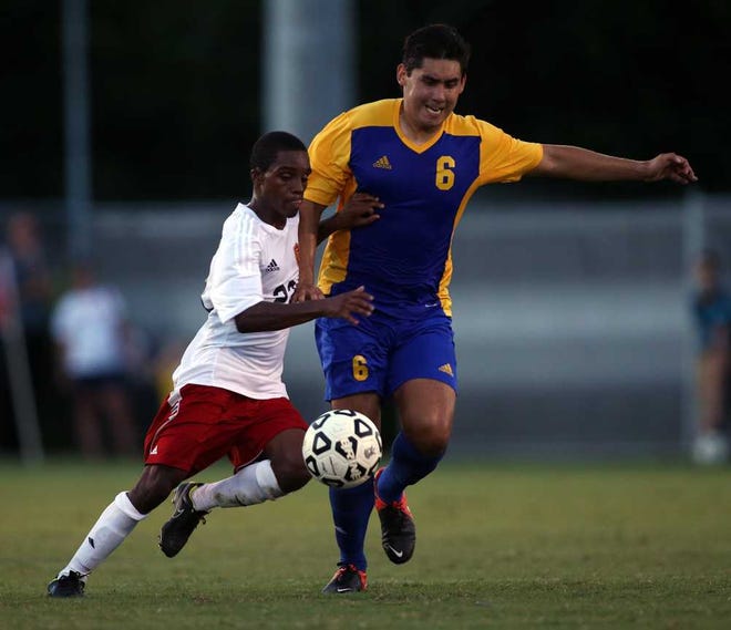 Flagler College midfielder Marco Warren was named to the preseason Peach Belt Conference team for the second straight year. Saints head coach John Lynch said the senior is sensational to watch. "On the ball, he's capable of doing things other people can't at this level." He's seen fighting for possession against Embry-Riddle's Jason Alvarez during a Sept. 4, 2014 match at Saints Field. PERRY KNOTTS/CORRESPONDENT