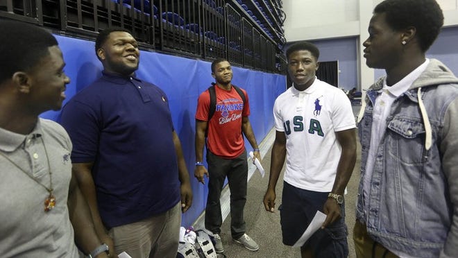 Pahokee High School football players, Jalen Patterson, (L), Aman Angram-Boldin, McArthur Burnett, Les’Kee Hessing, and Josh Holmes, prepares to have their photo taken during media day for south Florida high school football teams at Nova Southeastern University Aug. 08, 2015 in Fort Lauderdale. The event was sponsored by the Miami Dolphins. (Bill Ingram / Palm Beach Post)