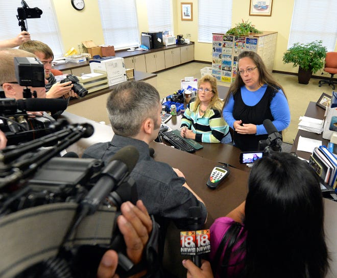 Rowan County Clerk Kim Davis, right, talks Tuesday with David Moore following her office’s refusal to issue marriage licenses at the Rowan County Courthouse in Morehead, Ky.
