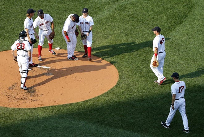 Interim manager Torey Lovullo (17) walks to the mound to remove Henry Owens, second from left, from the game in the second inning.