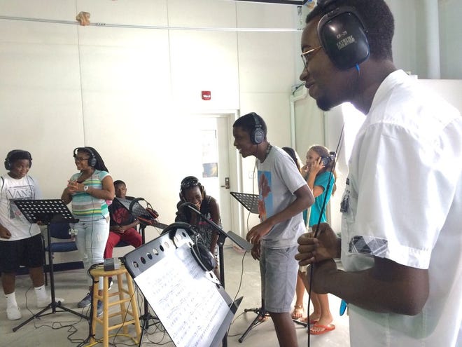 Students attending the CROP summer camp express their musicality while experimenting with audio equipment at the University of Florida Digital Worlds Institute. Special to the Guardian