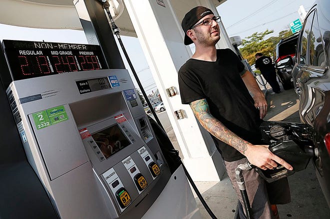 Justin Pasco, 26, of Brockton fills up at the Cumberland Farms in Whitman, where the price of gas is $2.13 a gallon, Wednesday, Sept. 2, 2015.
