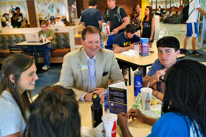 Dave Lewis, UCO's new director of alumni relations, visits with students (clockwise from right) Blake Dusenberry, Raela Hudson and Amanda Arias, all UCO freshmen, and Katelin Wood, staff member for YoungLife, a non-denominational student group, at lunch in the Nigh Center on Thursday. [Photo by Jim Beckel, The Oklahoman]