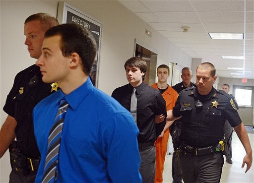 From left, Tyler Porter, Keefer McGee, and Dylan Lahr are escorted after their sentencing hearing, Thursday, Sept. 3, 2015, in Lewisburg, Pa., for a rock-throwing incident last year that caused severe brain trauma to an Ohio schoolteacher as she passed through Pennsylvania in the dead of night. (Amanda August/The Daily Item via AP)