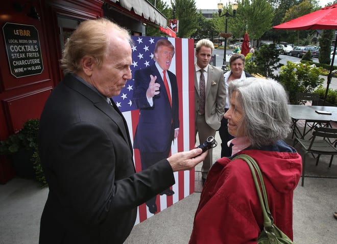 Donald Trump supporter Chris Harris talks to Peggy Bosley during a stop at 5th Street Public Market about their views on the presidential candidate before being asked by managers of the mall to leave the property. (Chris Pietsch/The Register-Guard)