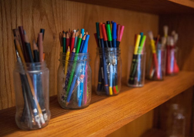 Colored pencils and brushes in reused spaghetti jars make a functional and attractive display in Columbia sustainability manager Barbara Buffaloe’s home on Hilltop Drive.