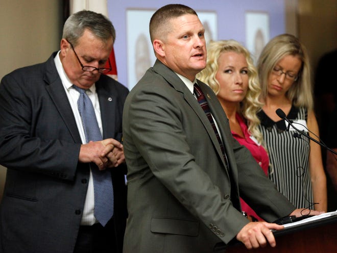 St. Augustine Beach Police Chief Robert Hardwick speaks during a press conference at the St. Johns County Sheriff's Office Friday afternoon, August 20, 2015. St. Johns County Sheriff David Shoar, left, and sisters of murder victim Carl Starke, Carli Durden and Chanel Starke, right, stand nearby.