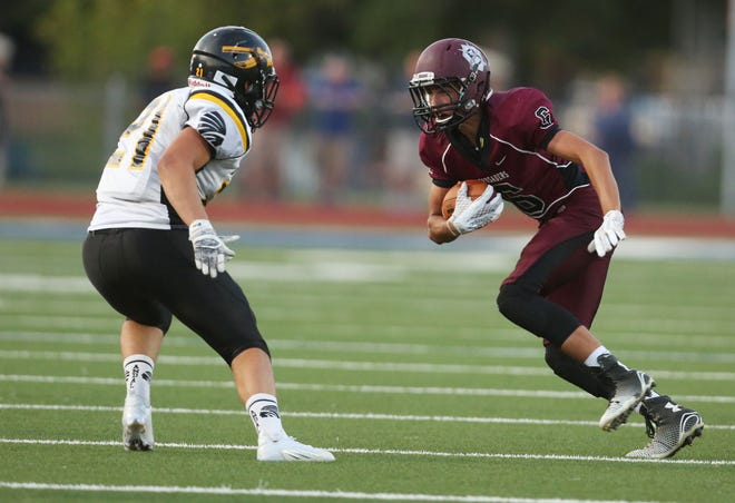 Buhler's Tanner Lackey attempts to get past Andale's Matthew Maus in the second quarter Friday, Sept. 4, 2015 at Gowans Stadium.