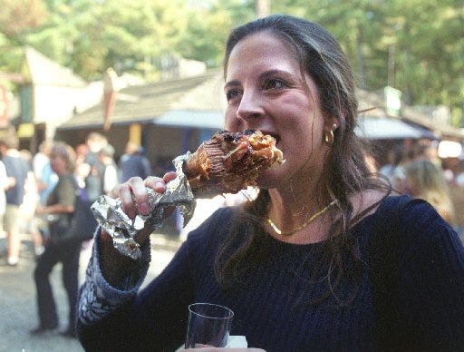 Huge turkey legs are part of the fun at King Richard's Faire. In this 2005 photo, 
Heidi Burke, of Marlborough, Massachusetts, eats one she bought at a booth there. The Providence Journal / Sandor Bodo, file