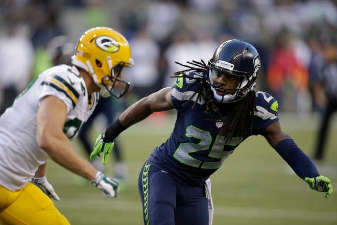 ADVANCE FOR WEEKEND, SEPT. 4-7 - FILE - In this Sept. 4, 2014, file photo, Seattle Seahawks cornerback Richard Sherman (25) begins pass coverage against a Green Bay Packers receiver during an NFL football game in Seattle. "Step-kick" is simply the name the Seahawks have attached to how their cornerbacks are going to play when aligned in press coverage on wide receivers at the line of scrimmage. No one has figured out this style of play better than Sherman. He is the prototype in Seattle. Tall, long, smooth and patient. He has all the attributes that equate success for a cornerback playing this style. (AP Photo/Stephen Brashear, File)