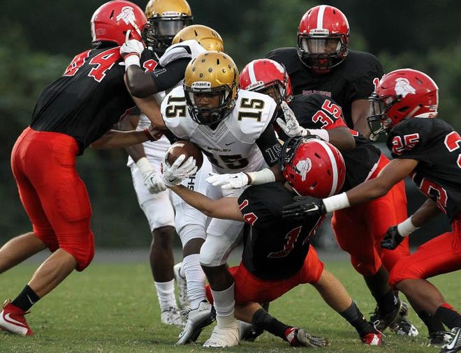 Shelby's Antwan Wright, 15, is brought down by host of South Point defenders during their game Friday night in Belmont.