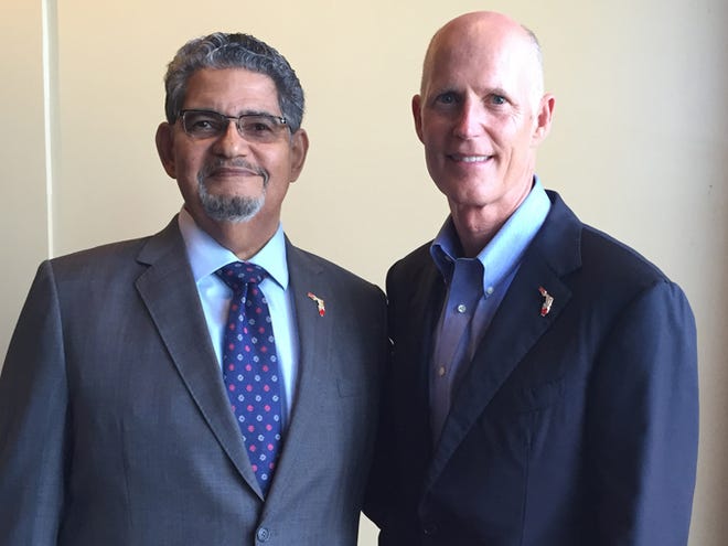 John Colon, of University Park, left, with Florida Gov. Rick Scott on Aug. 18 in Riverview. (Courtesy photo)