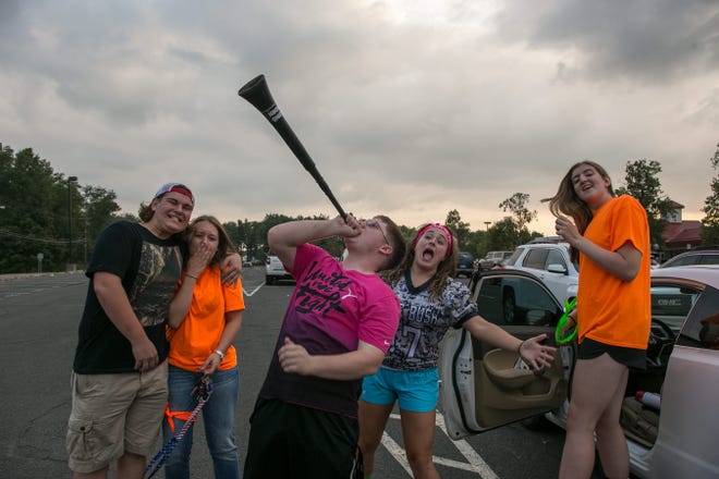 Pine Bush fans, from left, Hunter Lustgarten, Darriane Morley, Ryan Holzmuller, Sydney Hofmann and Kate Cain tailgate before Friday night's opener against visiting Wallkill. Holzmuller warms up the crowd with a loud horn. Allyse Pulliam/For the Times Herald-Record