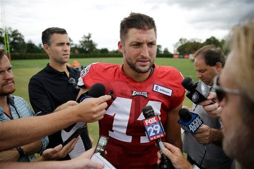 FILE - In this Aug. 20, 2015, file photo, Philadelphia Eagles quarterback Tim Tebow speaks with members of the media after NFL football training camp in Philadelphia. Two people familiar with the move say the Eagles released Tebow. Both sources spoke on condition of anonymity, Saturday, Sept. 5, 2015, because the team hasn't announced the decision.(AP Photo/Matt Rourke, File)