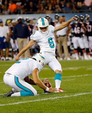 Miami Dolphins kicker Caleb Sturgis (9) kicks a field goal front he hold of punter Brandon Fields against the Chicago Bears during the first half of an NFL preseason football game in Chicago, Thursday, Aug. 13, 2015. (AP Photo/Charles Rex Arbogast)