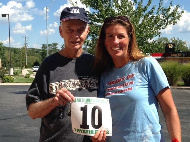 Race director Joe Duncan, left, poses with Columbia’s Mary Ellen Bradshaw after the runner completed her 10th-straight Heart of America Marathon last year.
