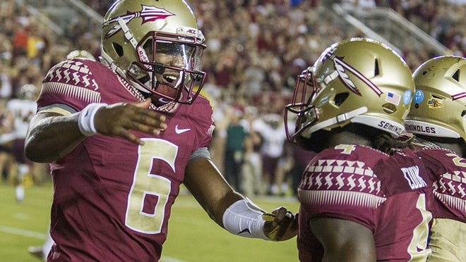 Florida State quarterback Everett Golson, left, celebrates the team's first touchdown with Dalvin Cook, during the first half of an NCAA college football game against Texas State in Tallahassee, Fla., Saturday, Sept. 5, 2015. (AP Photo/Mark Wallheiser)