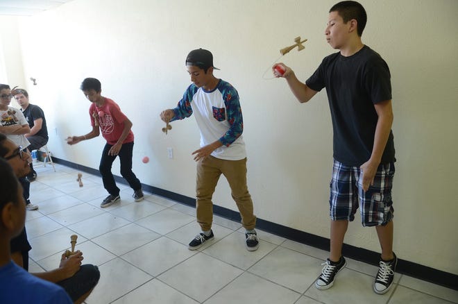 Teenagers participate in a Kendama tournament at the grand opening of JC Toys in Barstow on Sunday. 

David Pardo, Press Dispatch