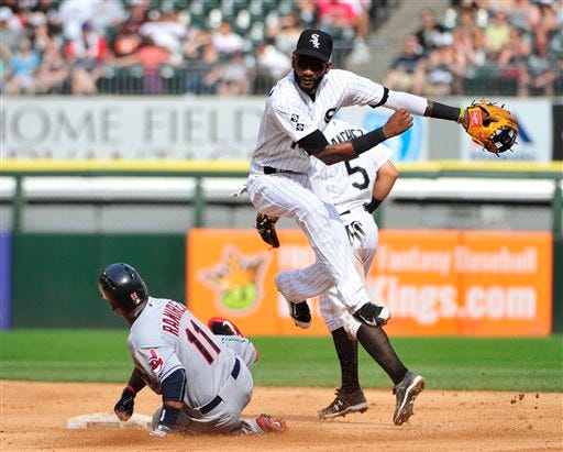 Chicago White Sox shortstop Alexei Ramirez, center, after forcing out Cleveland Indians' Jose Ramirez (11) throws to first base to complete a double play during the ninth inning of a baseball game Monday, Sept. 7, 2015 in Chicago. The Indians won 3-2.