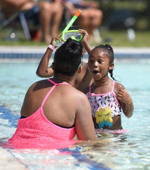 Iyanna Parker, right, plays with her mother Kisha Parker, both of Stroudsburg, at the Dansbury Park pool in East Stroudsburg as they enjoy the last day of summer Monday. (Amy Herzog/Pocono Record)