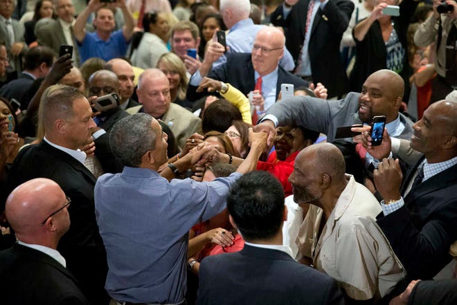 President Barack Obama greets members of the crowd after speaking at the Greater Boston Labor Council Labor Day Breakfast, Monday, Sept. 7, 2015, in Boson. Obama will sign an Executive Order requiring federal contractors to offer their employees up to seven days of paid sick leave per year. (AP Photo/Andrew Harnik)