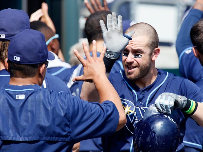 Tampa Bay Rays' Evan Longoria celebrates with teammates after hitting a two-run home run against the Detroit Tigers during the fourth inning of a baseball game at Comerica Park Monday, Sept. 7, 2015, in Detroit.