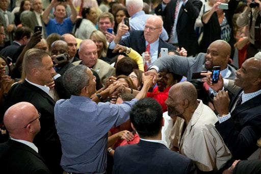 President Barack Obama greets members of the crowd after speaking at the Greater Boston Labor Council Labor Day Breakfast, Monday, Sept. 7, 2015, in Boson. Obama will sign an Executive Order requiring federal contractors to offer their employees up to seven days of paid sick leave per year.