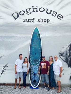 Special to The Log

From left, Don Oliver, Chris Kerr, owners Dog House Surf Shop, Keith Jett, artist Wicked Paint and Big Rooster Co. Cycles and Tattoos present Ruth Anne Heberle and her husband with the one of kind, airbrushed Paddle for the Promise Prize Drawing Paddle Board.