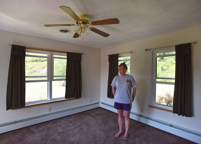 Tina Burkle stands in her new living room Sep. 4, 2015 in Deansboro, N.Y. The Burkles closed on their Deansboro home Wednesday Sep. 2 and started the process of purchasing the home approximately six weeks ago. "We went through a credit union that has all of our accounts," said Tina Burkle whose family purchased the home after their home in Vernon Center suffered flood damage two years ago.