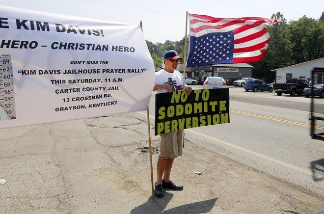 Ken Scott, from Denver, stands in support of Rowan County Clerk Kim Davis, outside the Carter County Detention Center, Saturday, Sept. 5, 2015, in Grayson, Ky. Since the U.S. Supreme Court legalized gay marriage in June, the vast majority of officials have abided by that ruling. However, Davis stopped issuing marriage licenses to any couple, gay or straight, in defiance of a federal court order, and was sent to jail on Thursday