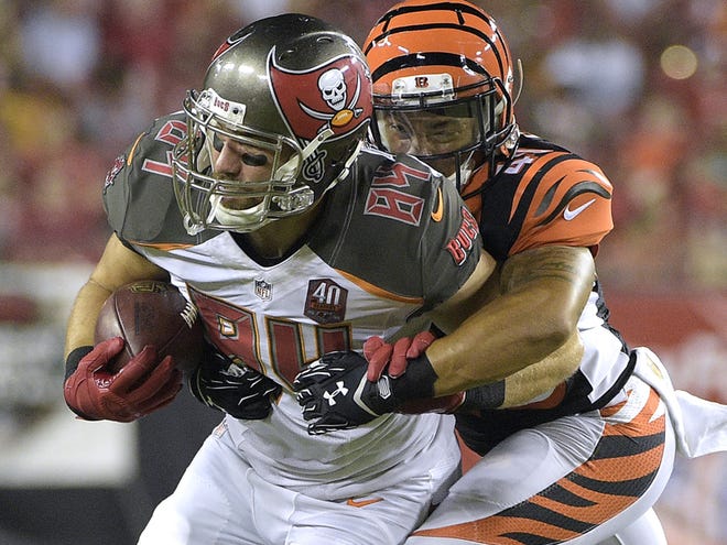 Tampa Bay Buccaneers tight end Cameron Brate, RIGHT, is stopped by Cincinnati Bengals free safety Derron Smith, left, during the third quarter of an NFL preseason football game Monday, Aug. 24, 2015, in Tampa.