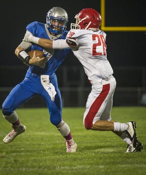 Rancocas Valley's Xavier Santos sacks Northern Burlington quarterback Tyler O'Dell in a game last year. Santos is a top returning defender for the Red Devils. (PHOTO Bryan Woolston / @woolstonphoto)