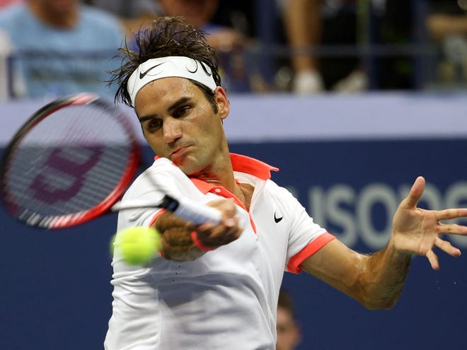 Roger Federer, of Switzerland, returns a shot to Richard Gasquet, of France, during a quarterfinal match at the U.S. Open tennis tournament, Wednesday, Sept. 9, 2015, in New York.