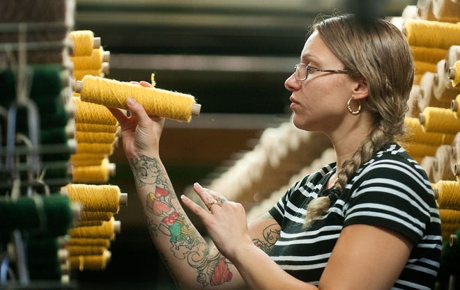 Benta Poeck, 30, of Philadelphia, adds a pencil tube of yellow yarn onto a loom for one of the papal carpets last month. The historic Langhorne Carpet Co. is weaving a 75-foot-long runner for Pope Francis' visit to Philadelphia, as well as two other carpets that will be used in the rectory at the Basilica of Saints Peter and Paul in Philadelphia.
