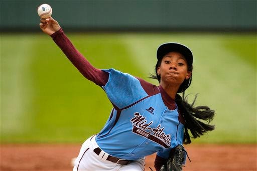 In this Aug. 15, 2014, file photo, Pennsylvania's 13-year-old Mo'ne Davis delivers in the first inning against Tennessee during a baseball game in United States pool play at the Little League World Series tournament in South Williamsport, Pa. Little League is getting younger. The organization announced Thursday it is changing its age requirement, phasing out 13-year-olds from the league. (AP Photo/Gene J. Puskar, File)