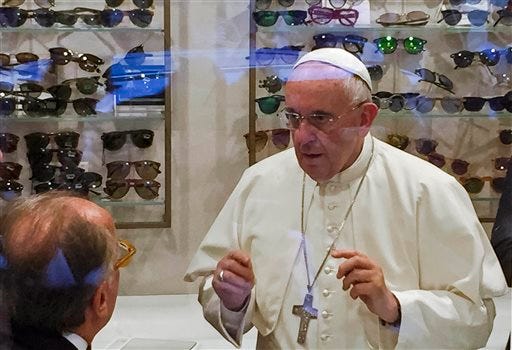 In this Thursday, Sept. 3, 2015 file photo, Pope Francis tries on a pair of spectacles in an eyeglass store in via del Babuino, in central Rome, . Pope Francis has slipped out of the Vatican to shop for new lenses for his glasses. Two weeks after spurring a viral frenzy with a trip to a Rome eyeglass shop, Pope Francis is embarking on his first journey to the greatest fishbowl of all: America. (Daniel Soehne via AP, File)