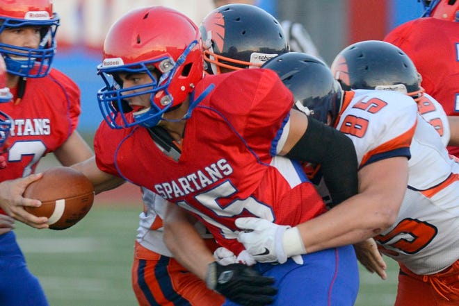 New Hartford's Dom Pfisterer is tackled by East Syracuse-Minoa's Jeremy Perry during Friday's game at New Hartford. ES-M won 52-34.