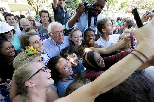 FILE - In this Sept. 3, 2015 file photo, Democratic presidential candidate, Sen. Bernie Sanders, I-Vt., poses for a photo with supporters in Grinnell, Iowa. The Bernie Sanders phenomenon has been almost entirely driven by white voters. Now heís out to overcome hurdles with black voters who are still learning about him and could shape whether his insurgent campaign for the 2016 Democratic nomination can last. (AP Photo/Charlie Neibergall, File)