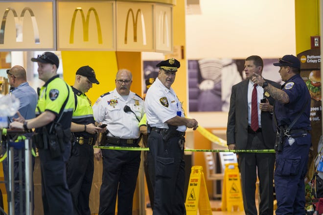 Police and emergency responders stand outside a McDonald's located inside Union Station in Washington, Friday, Sept. 11, 2015, after a security guard shot a suspect who attacked a worker with a knife at the restauran. (AP Photo/Evan Vucci)