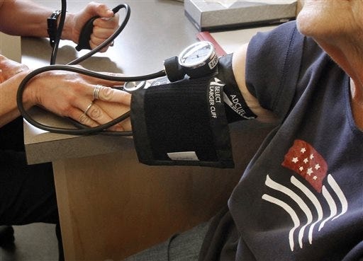 A patient has her blood pressure checked by a registered nurse in Plainfield, Vt. A major new U.S. study shows treating high blood pressure more aggressively than usual cuts the risk of heart disease and death in people over age 50. The Associated Press