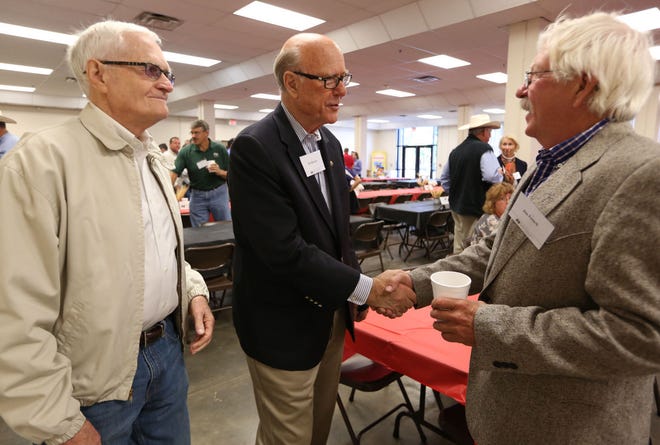 Senator Pat Roberts, center, shakes hands with Jim French, with Harold Stones, left, before the start of the annual Farm Bureau breakfast at the Kansas State Fair Saturday, Sept. 12, 2015.