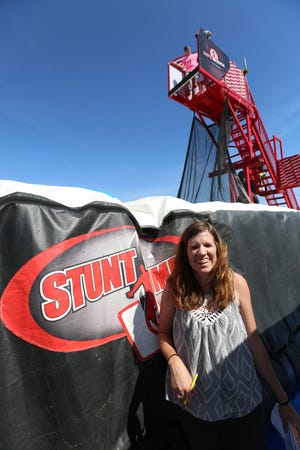 Reporter Amy Bickel smiles after jumping of the Zero Shot - a stunt jump with a platform 20 feet in the air.