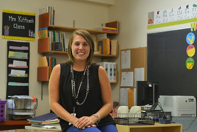 Allison O'Lenick Kittner poses in her classroon at Winfield Elementary. The new third grade teacher graduated from West High.