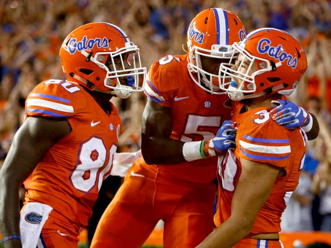 Florida Gators tight end DeAndre Goolsby (30) celebrates with wide receiver Ahmad Fulwood (5) and tight end C'yontai Lewis (80) after scoring a touchdown against the East Carolina Pirates during the first half at Ben Hill Griffin Stadium on Saturday, Sept. 12, 2015 in Gainesville, Fla. (Matt Stamey/Staff photographer)