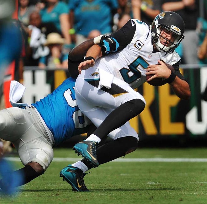 Jaguars quarterback Blake Bortles (5) is sacked by Panthers outside linebacker Thomas Davis in the fourth quarter on Sunday at EverBank Field.  Will.Dickey@jacksonville.com