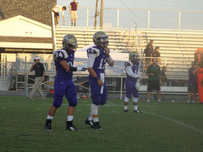 Ascension Catholic running back Jacob Lagrange (No. 24) and quarterback DC Mattingly (No. 12). Photo by Kyle Riviere.