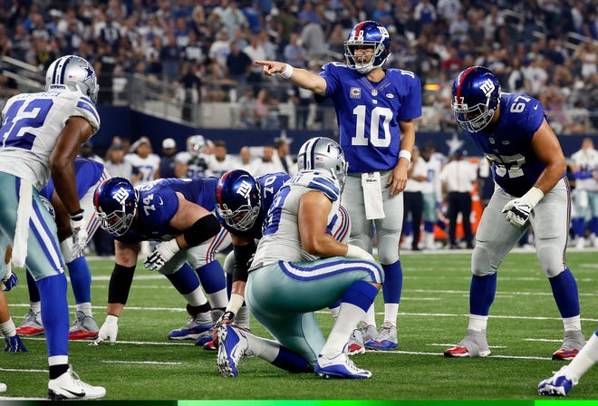New York was about to put a damper on another festive prime-time opener Sunday night. Instead, the Giants were stunned 27-26 on a winning drive by Tony Romo after Manning admittedly made a crucial mistake. (AP Photo/Tony Gutierrez)