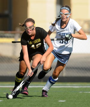 Moorestown's Grace Kuszmaul (46) works her way down field as Shawnee's Krista Hoffman (39) chases her during Tuesday afternoon's game at Shawnee High School.